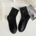 Black mid-calf socks featuring delicate ruffle cuffs and elegant satin ribbon bows for sweet style. - One Size / Small Bowknot Black