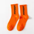 Orange mid-tube socks featuring black calabasas letters, perfect for hip-hop streetwear styles. - One Size / Crew Socks / Orange