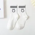 Cute white mid-tube cotton socks with black stripes and sweet smiley face design, casual style. - One Size / White