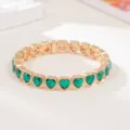 Gold-tone elastic bracelet featuring vibrant green heart-shaped gems, stylish and versatile. - Green Heart Gem Style (SL1575)