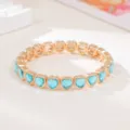Gold-tone elastic bracelet with vibrant blue heart-shaped crystals, stylish fashion accessory. - Blue Heart Rhinestone Style (SL1576)