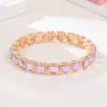 Fashionable gold-tone stretch bracelet featuring sparkling purple heart crystals for daily wear. - Purple Heart Rhinestone Style (SL1578)