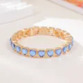 Gold-toned elastic bracelet featuring stunning blue heart-shaped crystal stones for daily wear. - Blue Heart Crystal Style (SL1581)
