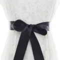 Elegant white lace dress paired with a wide black satin bow belt for bridal elegance. - With Black Ribbon