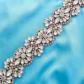 Close up detail shot of sparkling rhinestone bridal belt applique with rose gold flowers. - Rose Gold