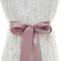 White lace wedding dress variant featuring a elegant pink satin ribbon bow waistband belt. - With Antique Purple Ribbon