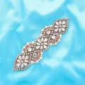 Detailed shot of sparkling rhinestone bridal belt applique with rose gold setting and pearls. - Rose Gold
