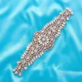 Close-up detail of a sparkling rhinestone bridal belt applique with rose gold metal base. - Rose Gold