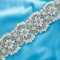 Detailed close-up of bridal crystal rhinestone applique belt sparkling gems and pearl elements. - Silver