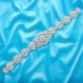 Detailed view of silver bridal rhinestone applique with sparkling crystals and pearls. - Silver
