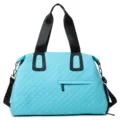 Light blue quilted travel duffel bag with black handles, spacious everyday shoulder bag. - Lake Blue