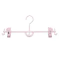 Roze kunststof broekhangers met verstelbare clips en draaibare haak voor kleding. - Roze
