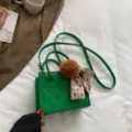 Green quilted crossbody bag with stylish pom-pom and scarf charm, trendy commuter tote purse. - Green