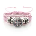 Pink braided leather bracelet detail featuring central St. Benedict medal charm and metal beads. - Style 12 (JY9762) / Pink