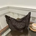 Detailaufnahme der braunen gesteppten Nylon Umhängetasche mit breitem Schulterriemen. - Kaffeebraun