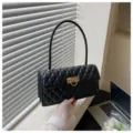 Black quilted underarm bag with metal lock, elegant baguette shoulder bag for women. - Black