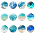 Close-up view of round glass fridge magnets featuring stunning ocean wave and beach patterns. - Set of 12 / Set of 12