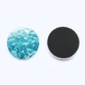 Detail shot of round ocean water wave glass fridge magnet with crystal front and back. - Style 6