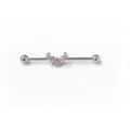Close-up detail of silver industrial barbell body piercing with pink crystal butterfly. - Pink Butterfly