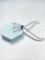 Detail shot of transparent acrylic body piercing closing pliers on blue hexagonal prop. - Disposable Closing Plier