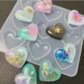 Clear 9-cavity heart silicone mold for DIY UV resin crafts with glitter and accessories. - 9-Cavity Heart / Clear