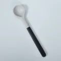 Two-tone silicone kitchen solid spoon with black handle for non-stick cooking and stirring. - Black Silicone Solid Spoon with Flat Plastic Handle