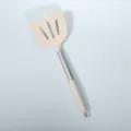 Beige silicone slotted spatula with stainless steel handle, heat-resistant kitchen tool. - Khaki