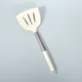 Silicone slotted spatula with stainless steel handle, white kitchen cooking tool for home use. - Cream