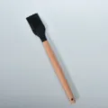 Silicone basting brush with solid wood handle, ideal for kitchen barbecue and oil brushing. - Round Wooden Handle Silicone Pastry Brush / Black