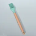 Silicone basting brush with wooden handle for baking, grilling, and cooking oil application. - Round Wooden Handle Silicone Pastry Brush / Dark Green