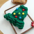 Close-up view of the green knitted pet sweater with colorful pom-poms, detail shot for puppies. - XS / Christmas Tree Pompom Style / Christmas Green