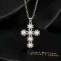 Close-up van een zilveren kruisketting met delicate parels en sprankelende zirkoniasteentjes. - Parel Kruis Ketting / Zilver