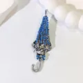 Elegant silver-toned folded umbrella brooch featuring vibrant blue rhinestone inlay for suits - Silver Blue