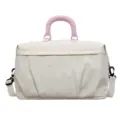 Pink polka dot travel duffel bag with handles and shoulder strap for fitness and gym. - Off White