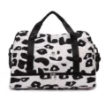 Large capacity travel duffel bag with black handles, stylish leopard print weekend bag for women. - Black Cow Print