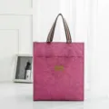 Pink waterproof student lunch tote bag with striped handles and front pocket for daily use. - Pink Medium