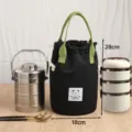 Effen cilindrische lunchtas met trekkoord, waterdichte bento handtas met groene handvatten. - Zwart