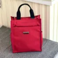 Red multi-layer canvas tote bag with black handles and side mesh pockets, perfect for daily commuting. - 808 Red Tag