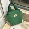 Donkergroene canvas tote tas met zijzakken en stevige dubbele handvatten voor dagelijks. - Groen