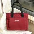 Red casual nylon tote bag daily commute handbag with black handles and front pocket variant. - 0908 Wine Red