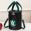 Zwarte ronde geïsoleerde lunchtas met groene handvatten en ML-logo, handige draagtas. - Klein zwart / diam. 16 h 22