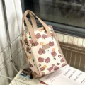 Waterproof insulated lunch bag with cute brown bear print and sturdy canvas handles. - Beige Blush Bear