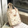 Waterproof insulated lunch bag with cute doodle print, portable thermal bento tote for work. - Beige Music Girl
