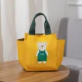 Leuke canvas lunchtas voor dames, gele draagtas met groen handvat en schattige berenprint. - Geel