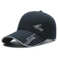 Close-up view of navy blue baseball cap with white brim trim and stylish sporty text print details. - Adjustable / Navy Blue