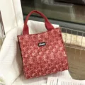 Stylish red canvas lunch bag with top handles and spacious interior for daily use. - Vintage Red