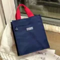 Grote kleurenblok lunchtas studentenhandtas bento tas met rode handvatten en voorzak - Blauw