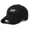 Detailed view of black teddy fleece baseball cap with white embroidered heart letter design. - Adjustable / Black