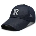 Close-up view of the breathable mesh baseball cap featuring detailed white letter embroidery. - Adjustable / Blue