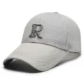 Close-up view of the breathable mesh cap detail showing the front embroidered R letter design. - Adjustable / Light Gray